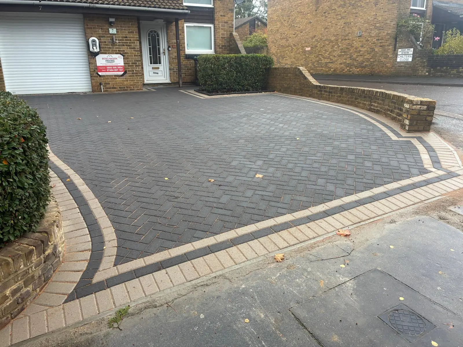 Finished grey herringbone block paving driveway with curved contrasting borders